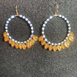 TORY BURCH gold covered puka shells hoops earrings .